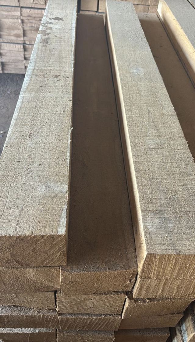 Stacked teak sawn sizes, rough-cut beams in the yard